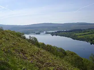 A lake surrounded by hills and trees