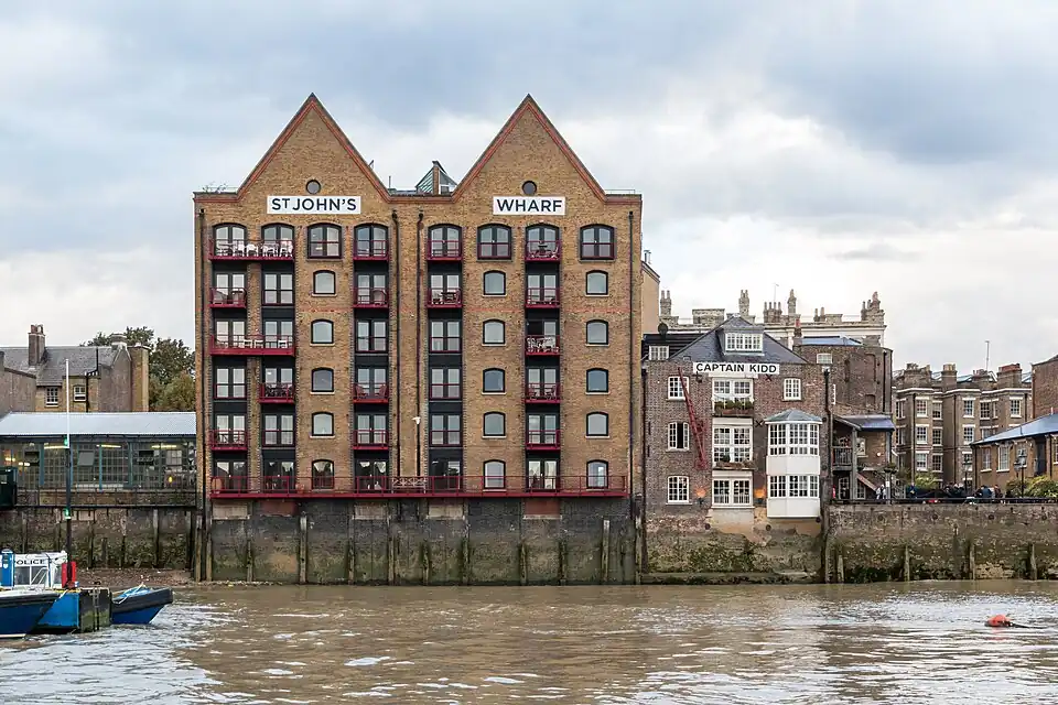 Wapping: warehouses—now flats and a pub—built on the wall