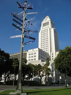 City Hall with a street sign indicating Los Angeles' twin towns and sister cities