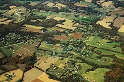Aerial view of some housing and farmland