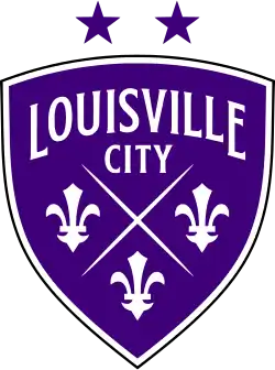 A three-sided purple shield logo with a white outline. Each of the three edges is curved, and the top edge is shorter than the left and right edges. It reads "LOUISVILLE" in large subtly-serifed white lettering that forms an arch along the top of the shield. Just below it reads "CITY" in slightly-smaller non-arched lettering. The center and bottom of the shield is occupied by two fine lines forming an X, with three fleur-de-lis symbols to the left, right, and bottom of the X. The fleur-de-lis symbols are bold and somewhat angular; in particular, the central pedal comes to a point at the top. Above the shield are two purple stars symbolizing the team's two championships.