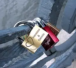 Padlocks engraved with the names of lovers, locked onto the wrought-iron railings of the Weidendammer bridge