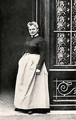 Woman standing at the entrance to a building