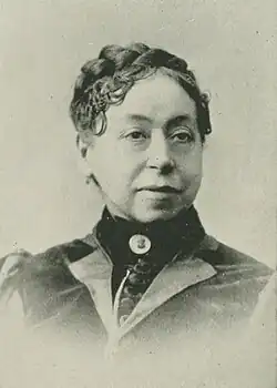B&W portrait photo of a middle-aged woman with her hair in an up-do.