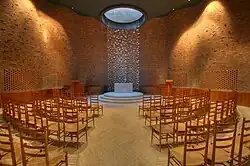 Sunlight cascades from a skylight onto a white marble altar