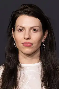 close-up of Anja Plaschg wearing a white see-through top, looking directly at camera with lips very slightly parted
