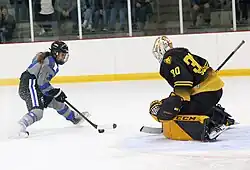 Schroeder defends in goal against Jonna Curtis of the Minnesota Whitecaps, November 2022