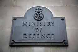 The Ministry of Defence plaque outside the south door of Main Building.