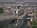 EMU-IBL approaching Bang Phai station with Tha Phra station in the background.