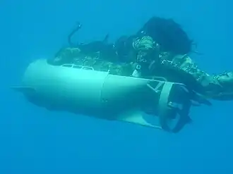 Two U.S. Marines of the MSPF operating a Diver Propulsion Device (DPD) used for stealthy approaches. [circa 1999]