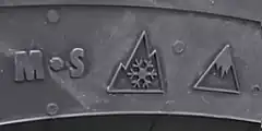 Tire sidewall bearing Mud and Snow, Three Peak Mountain SnowFlake, and Ice Grip Symbol designations.