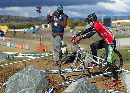 Image 6 Mountain bike trials Photo: Steve Bennett Joe Oakley (right), being penalised by the official (centre) for "dabbing" his foot on the ground during a mountain bike trials competition. Trials riding is a mountain biking discipline in which the rider attempts to pass through an obstacle course without setting foot to ground. Originating in Catalonia, it is popular within Europe and has a small following worldwide. More selected pictures
