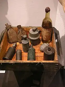 Two improvised satchel charges along with Sidolówka grenades and a Molotov cocktail, as used in the Warsaw Uprising