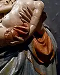 Detail of the tip of the cloak and apple