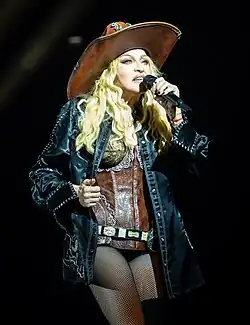 Madonna standing on a stage with a microphone