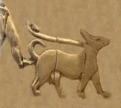 Naked man with penile sheath (fragment) walking a dog on a leash (Back, 5th register).[39][38] Naked and shaven-headed men are a regular fixture of the Art of Uruk and Sumerian religion.[39]