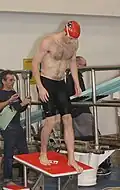 A man on a diving board wearing a jammer