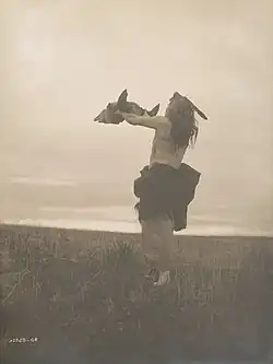 Mandan hunter with buffalo skull, c. 1909