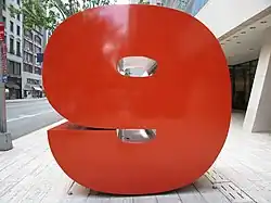 Large red shiny number 9 on a pedestal on a Manhattan sidewalk