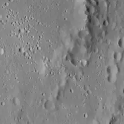 The southeastern peak ring has a lower albedo than the rest of the crater, and there are possible hollows on the peaks.
