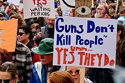 A person carrying a placard amidst a demonstration