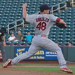 Marco Gonzales, facing away, throwing a pitch in a gray St. Louis Cardinals uniform
