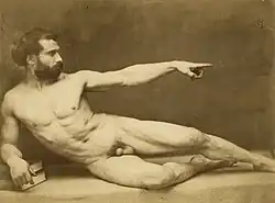 Black and white photograph of a nude figure in academic pose