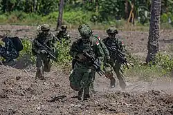 Members of the Singapore Armed Forces push forward in an amphibious assault exercise during Super Garuda Shield 2024 near Banongan, Indonesia, 5 September 2024.
