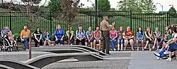 A Marine talking with visitors about the memorial