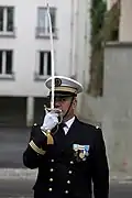 A Captain of Brest Naval Base presenting arms with his sabre