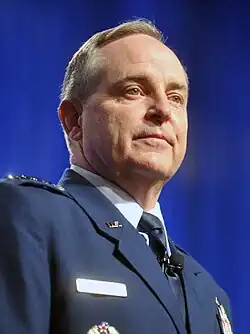 Headshot of a well-illuminated Walsh gazing towards the right
