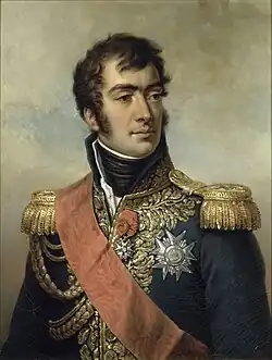 Painting of a clean-shaven man with dark hair and long sideburns. He wears a dark blue military uniform with gold epaulettes, high collar, elaborate lace, two medals and a velvet red sash.