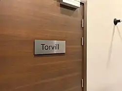 Room door with sign reading "Torvill".