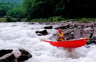 Whitewater canoeist Marty Plante paddling on Esopus Creek.