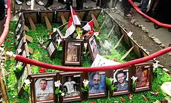 Roped-off rectangle of framed photographs