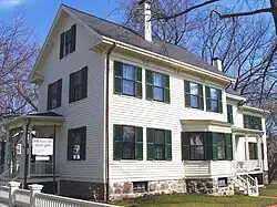 3 storey white wooden house