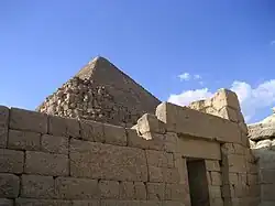 A stone pyramidal structure from a bottom angle