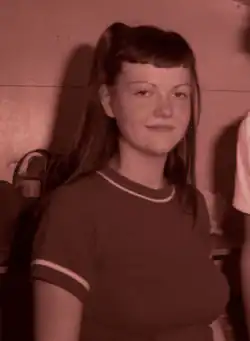 Meg White standing and smiling at the camera