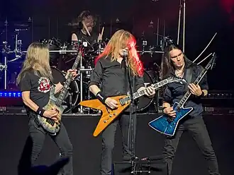 A four-piece band performing onstage