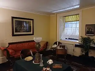 The family room, with furniture such as a dining table and a sofa
