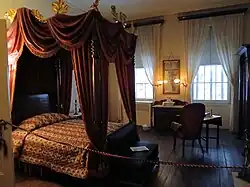 The front second-floor bedroom, which has a canopied bed