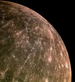 The rays of Hokusai crater (near central horizon) extend across much of the planet