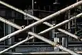 Part of scaffolding struts (being compressed) for construction work