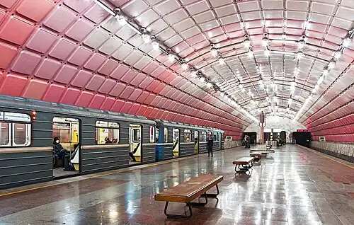 Underground station with a pink tiled ceiling