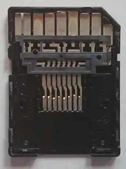 Dismantled microSD to SD adapter showing the passive connection from the microSD card slot on the bottom to the SD pins on the top