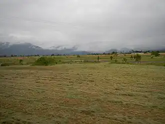 View across the fields to distant mountains, Midgenoo, 2013
