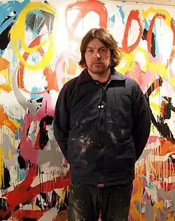 Welsh in front of his artwork in winter 2010