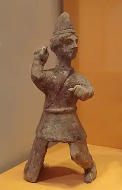 Mingqi (Chinese funerary statuette) of a young Central Asian man, with Saka-type caftan and conical hat reminiscent of early 3rd century AD Kushans. Later Han, 3rd century AD. Guimet Museum (MA 4660).[234]
