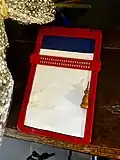 red and blue plastic full page slate with a wooden stylus