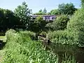 Culverted under the North Clyde Line railway